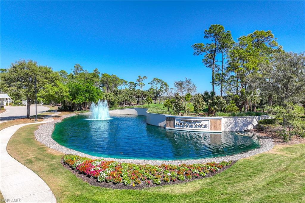 9309 Surfbird Court Naples, FL 34120 - Photo 45 of 45 Community / neighborhood sign with a water view and a lawn