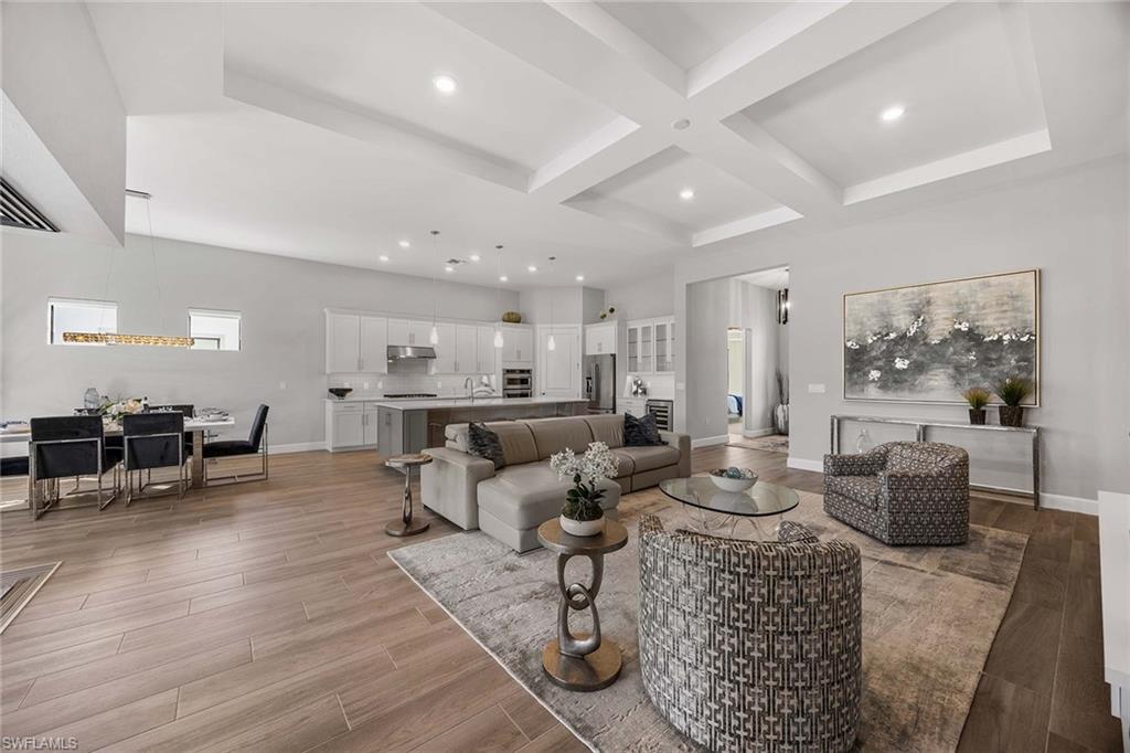 9309 Surfbird Court Naples, FL 34120 - Photo 9 of 45 Living area with coffered ceiling, beam ceiling, light wood-type flooring, and recessed lighting