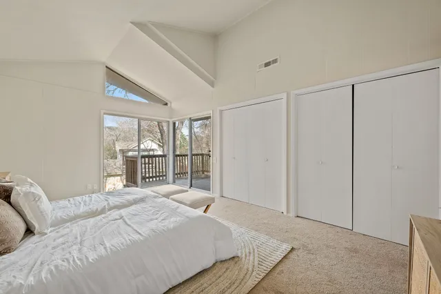 a bedroom with a large bed and a large window