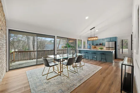 a dining room with furniture and wooden floor