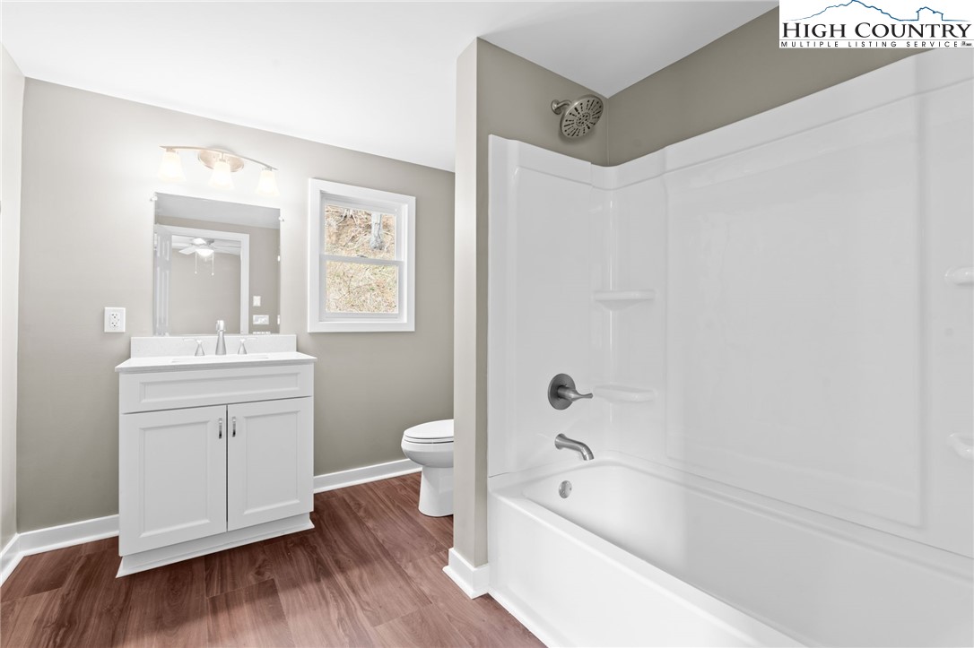 2015 Highway 194 Boone, NC 28607 - Photo 11 of 40 a bathroom with a bathtub shower sink mirror and toilet