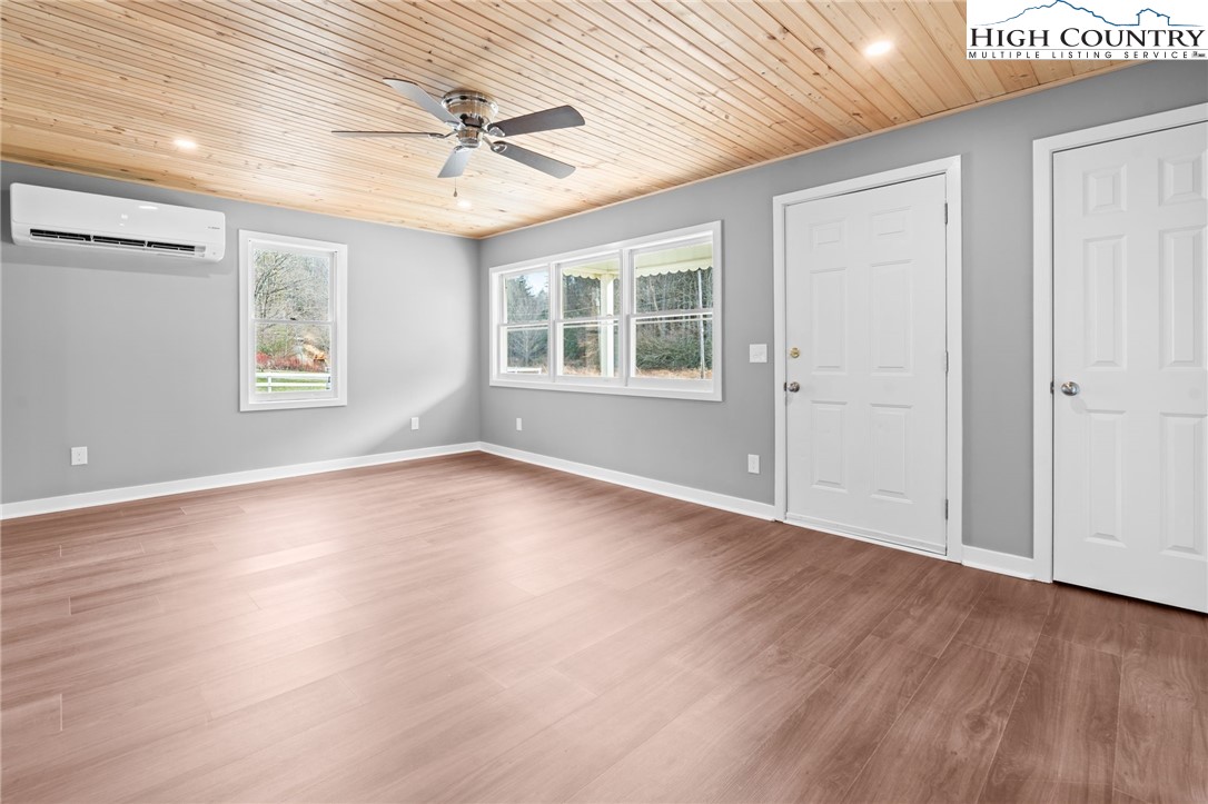 2015 Highway 194 Boone, NC 28607 - Photo 23 of 40 an empty room with wooden floor and windows