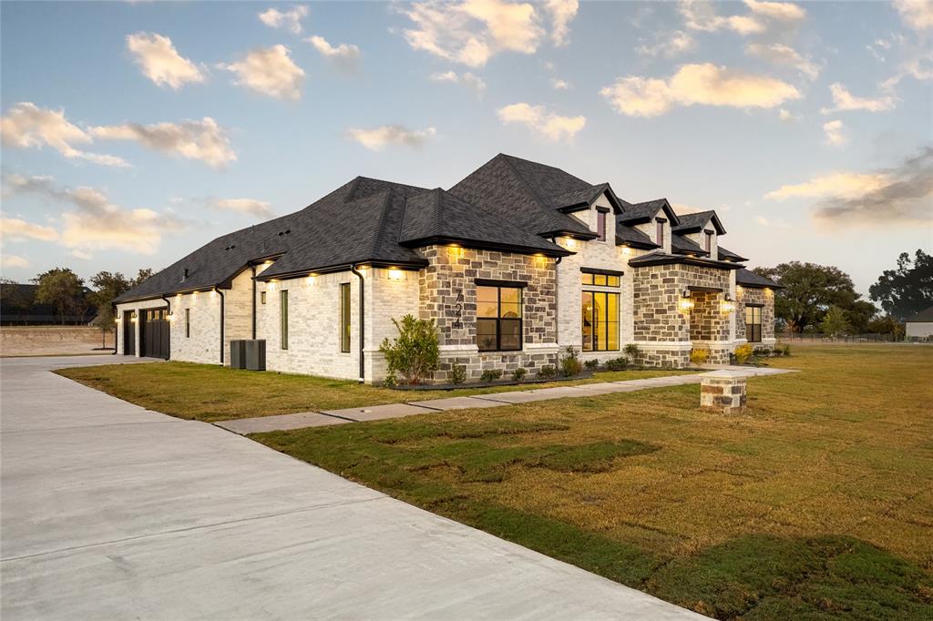 724 Cooper Trail Weatherford, TX 76087 - Photo 2 of 37 Stone and brick facade with dark-framed windows, a multi-gabled roofline, an attached two-car garage, and a concrete driveway