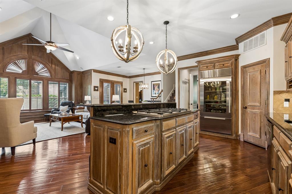 310 Deer Path Fairview, TX 75069 - Photo 13 of 40 a kitchen with a stove and wooden floor