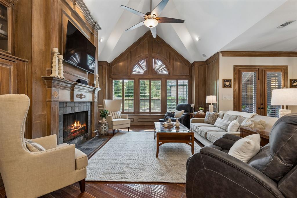 310 Deer Path Fairview, TX 75069 - Photo 15 of 40 a living room with furniture fireplace and a large window