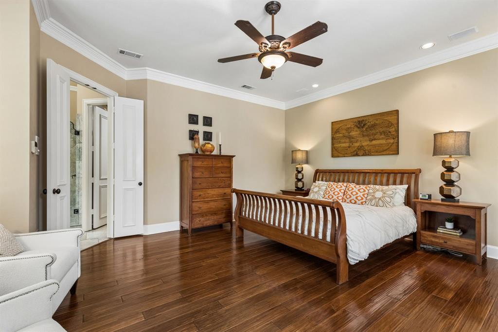 310 Deer Path Fairview, TX 75069 - Photo 21 of 40 a spacious bedroom with a bed and a chandelier