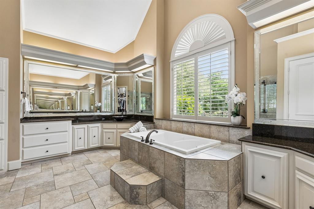 310 Deer Path Fairview, TX 75069 - Photo 24 of 40 a spacious bathroom with a granite countertop sink mirror and a bathtub