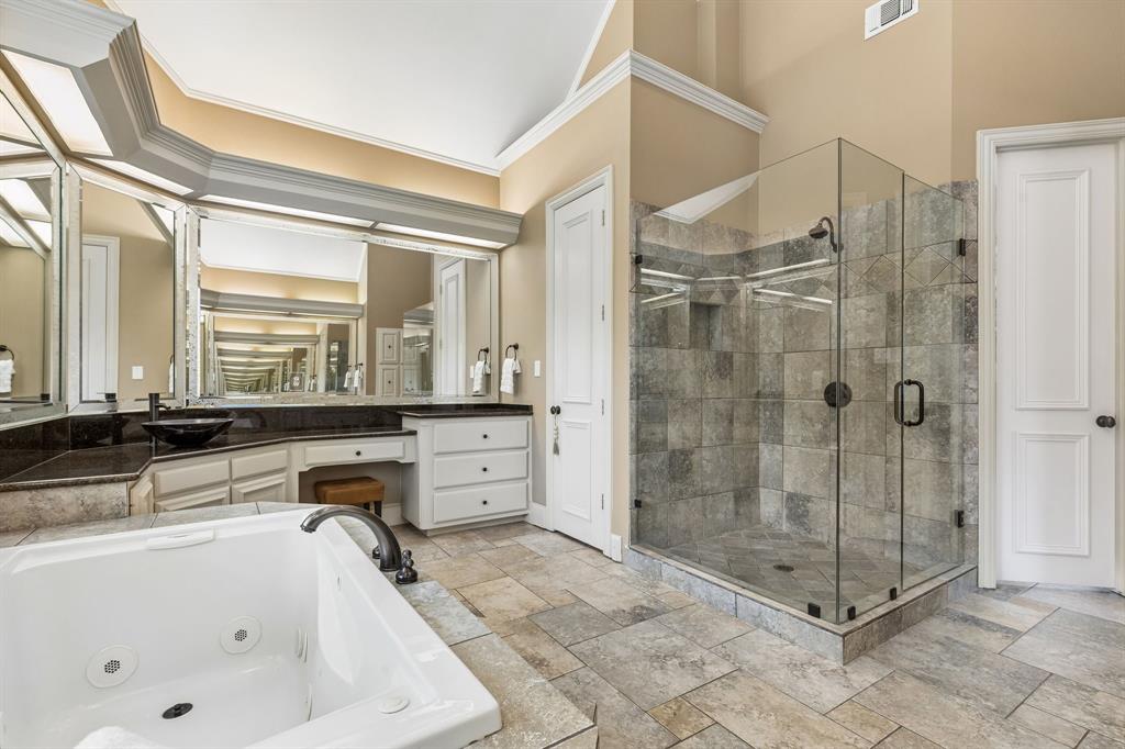 310 Deer Path Fairview, TX 75069 - Photo 25 of 40 a bathroom with a tub a sink and glass door