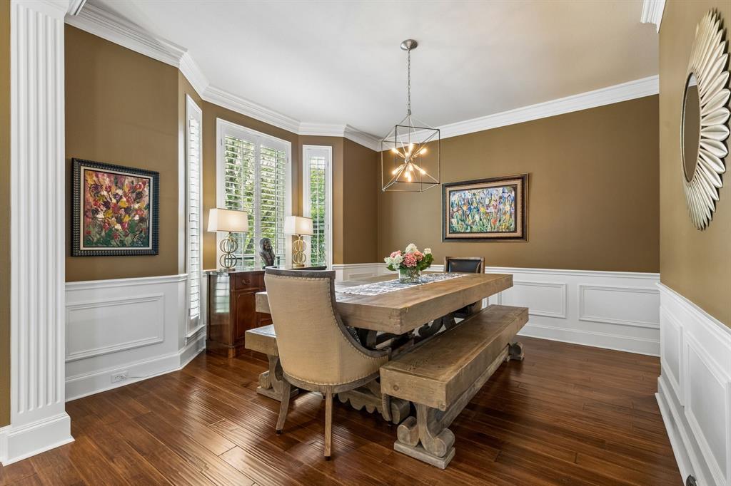 310 Deer Path Fairview, TX 75069 - Photo 8 of 40 a dining room with furniture a chandelier and wooden floor