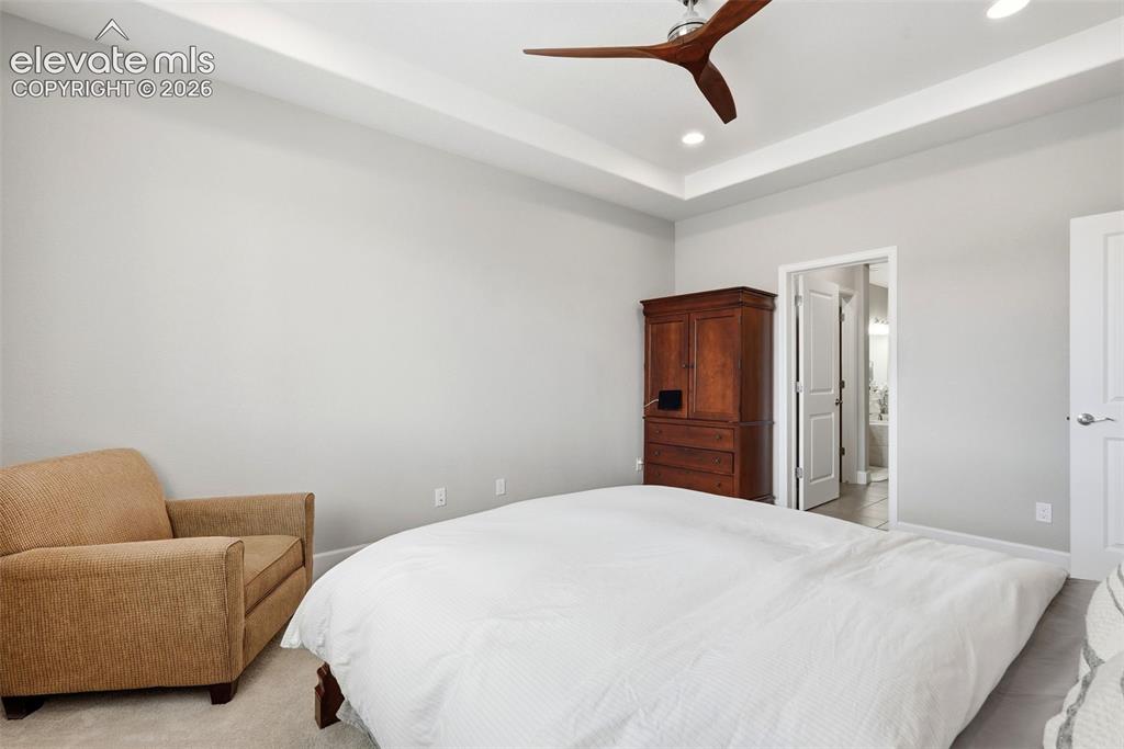 1394 Promontory Bluff View Colorado Springs, CO 80921 - Photo 26 of 47 a bedroom with a bed and couch