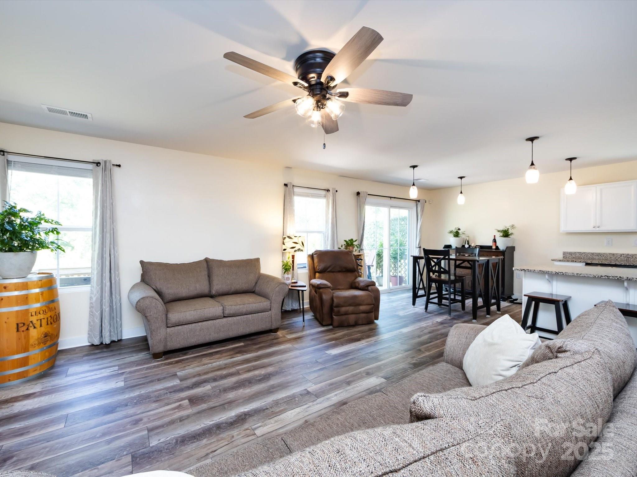 4499 Hunton Dale Road Northwest Concord, NC 28027 - Photo 12 of 43 a living room with furniture kitchen view and a wooden floor
