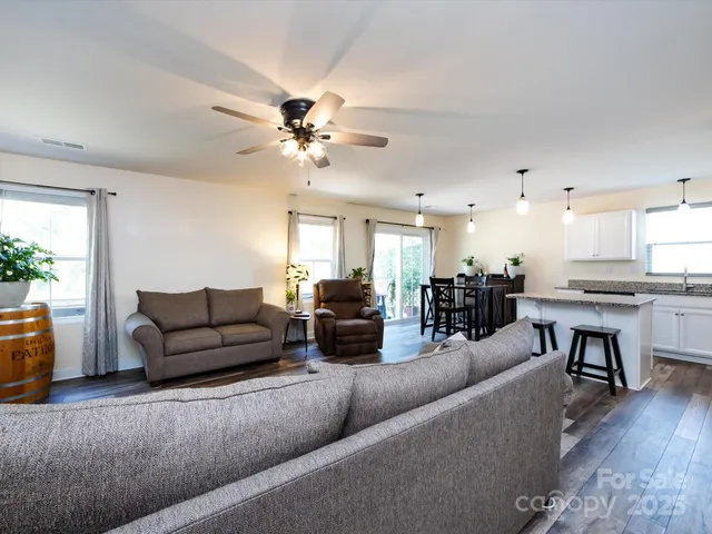 a living room with furniture and kitchen view