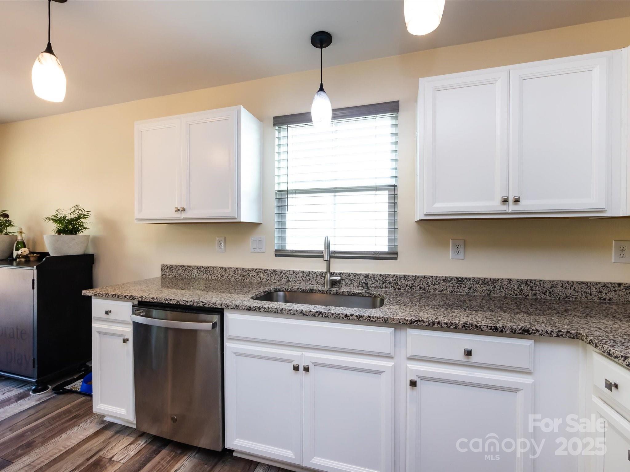 4499 Hunton Dale Road Northwest Concord, NC 28027 - Photo 17 of 43 a kitchen with granite countertop white cabinets and a window