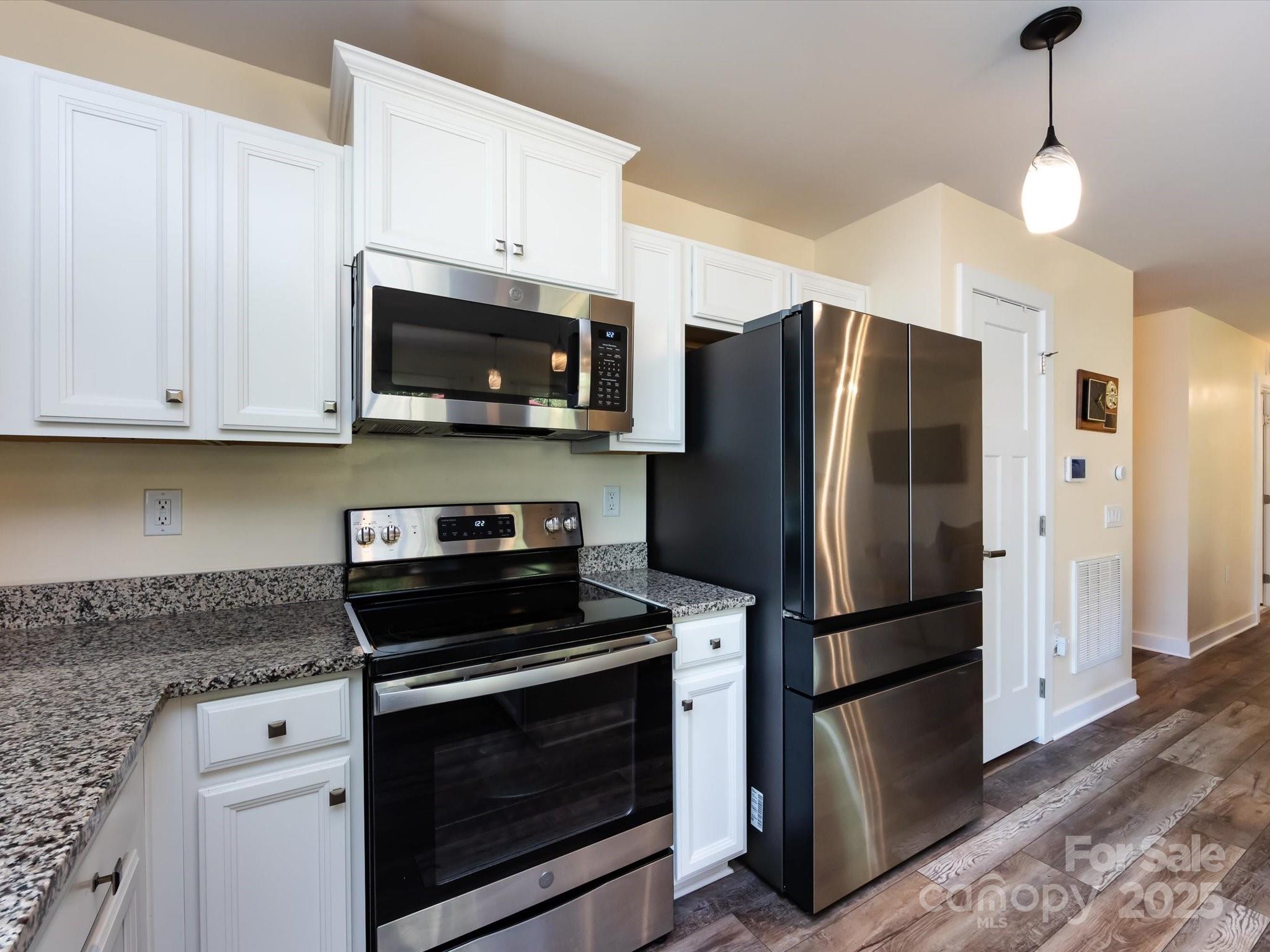 4499 Hunton Dale Road Northwest Concord, NC 28027 - Photo 19 of 43 a kitchen with appliances a microwave and cabinets