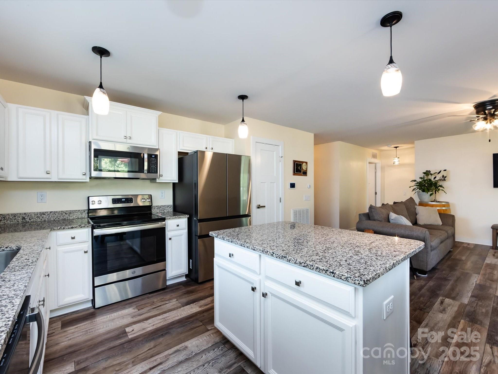 4499 Hunton Dale Road Northwest Concord, NC 28027 - Photo 20 of 43 a kitchen with stainless steel appliances granite countertop a sink stove and refrigerator