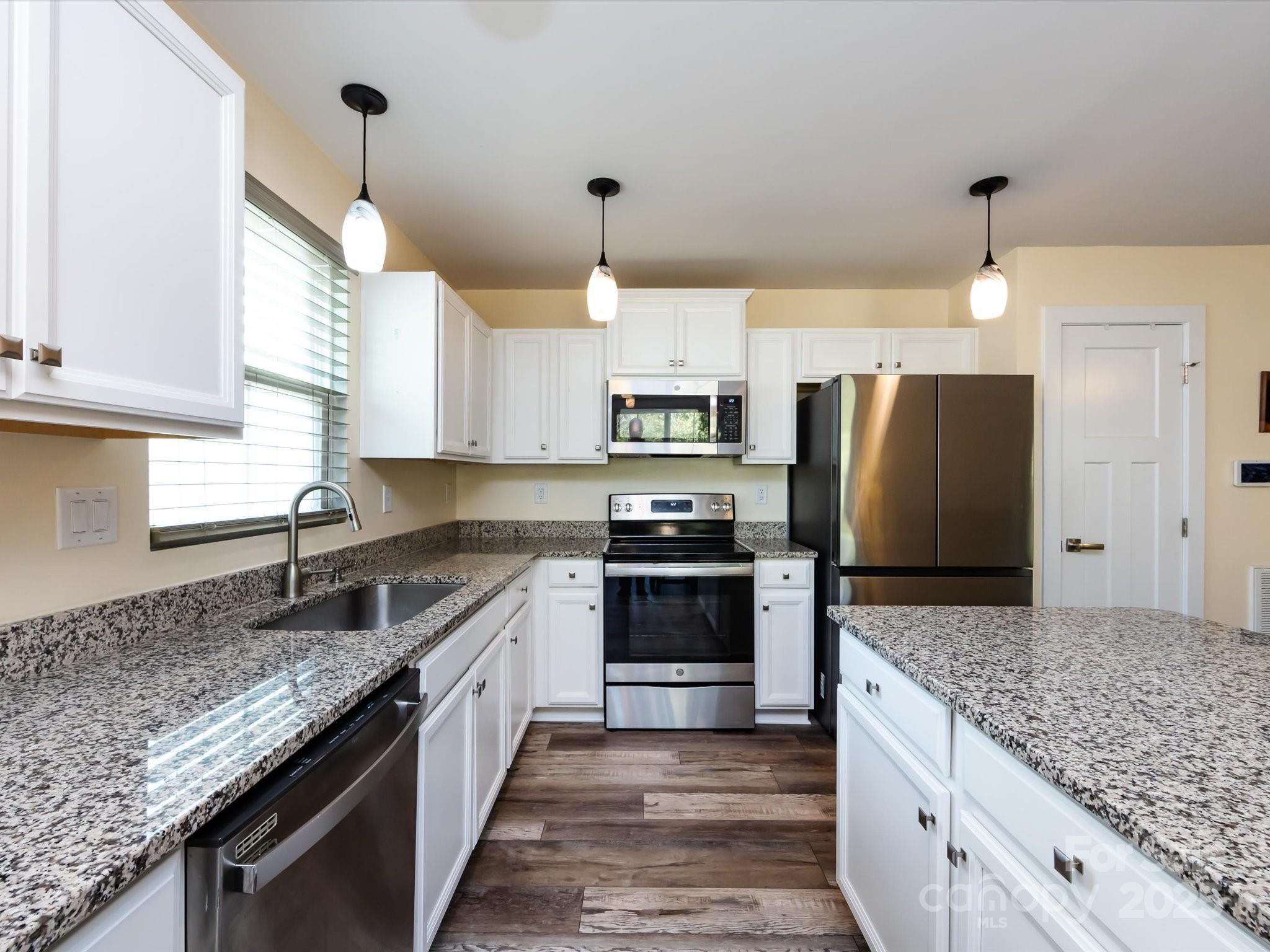 4499 Hunton Dale Road Northwest Concord, NC 28027 - Photo 21 of 43 a kitchen with a center island and stainless steel appliances