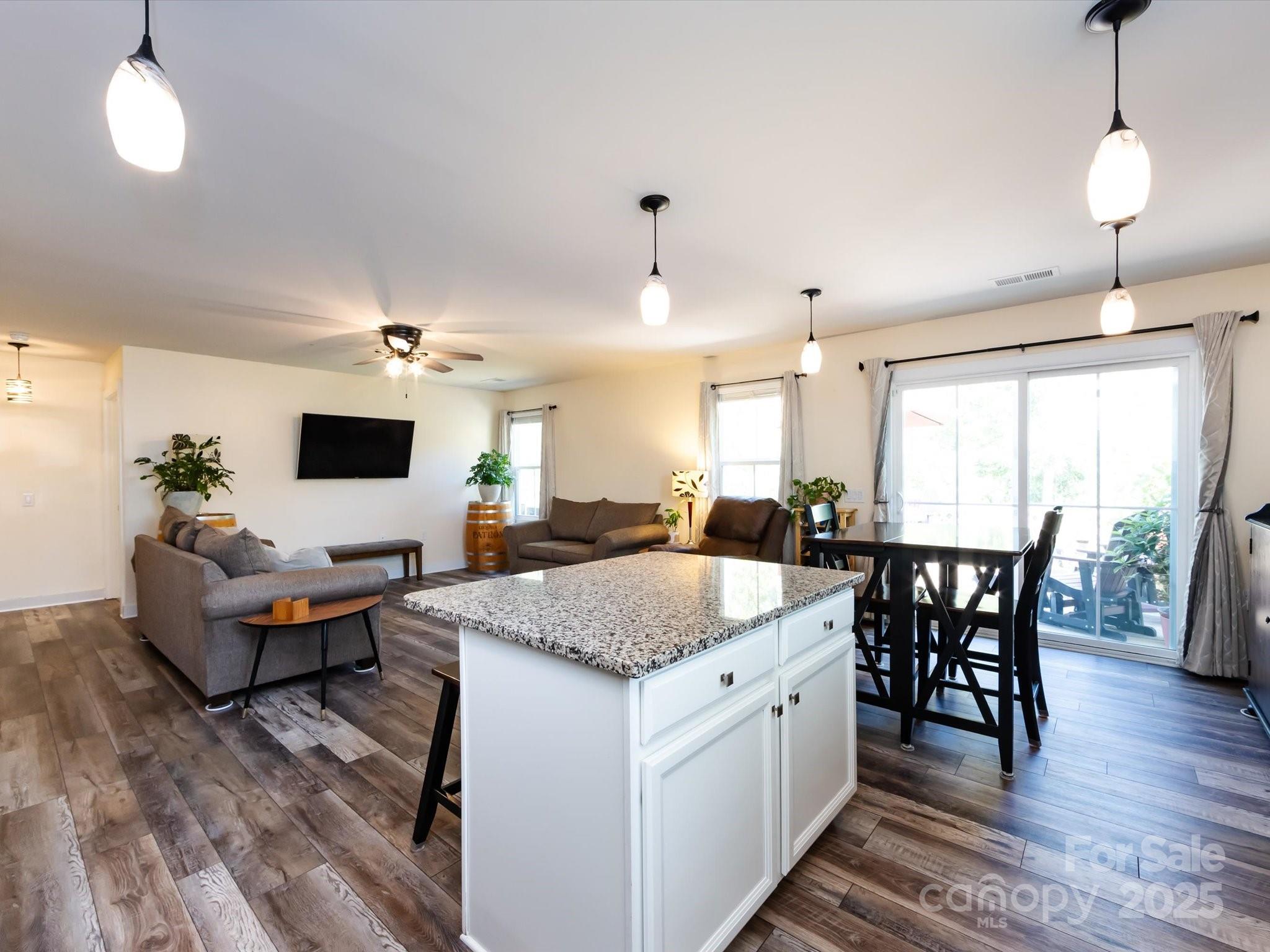 4499 Hunton Dale Road Northwest Concord, NC 28027 - Photo 22 of 43 a view of living room kitchen island dining table and chairs