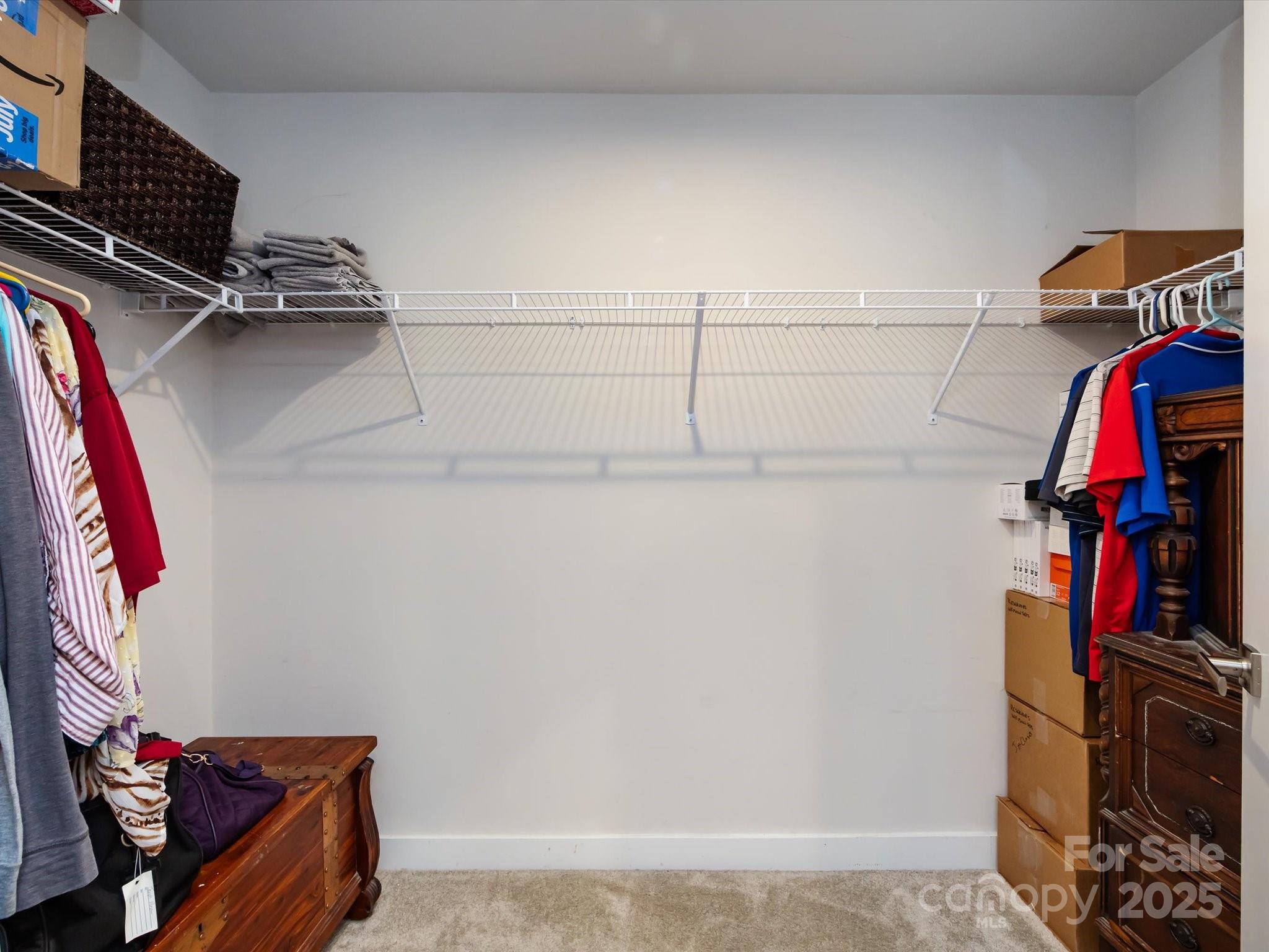 4499 Hunton Dale Road Northwest Concord, NC 28027 - Photo 28 of 43 a view of walk in closet with clothes and shoes
