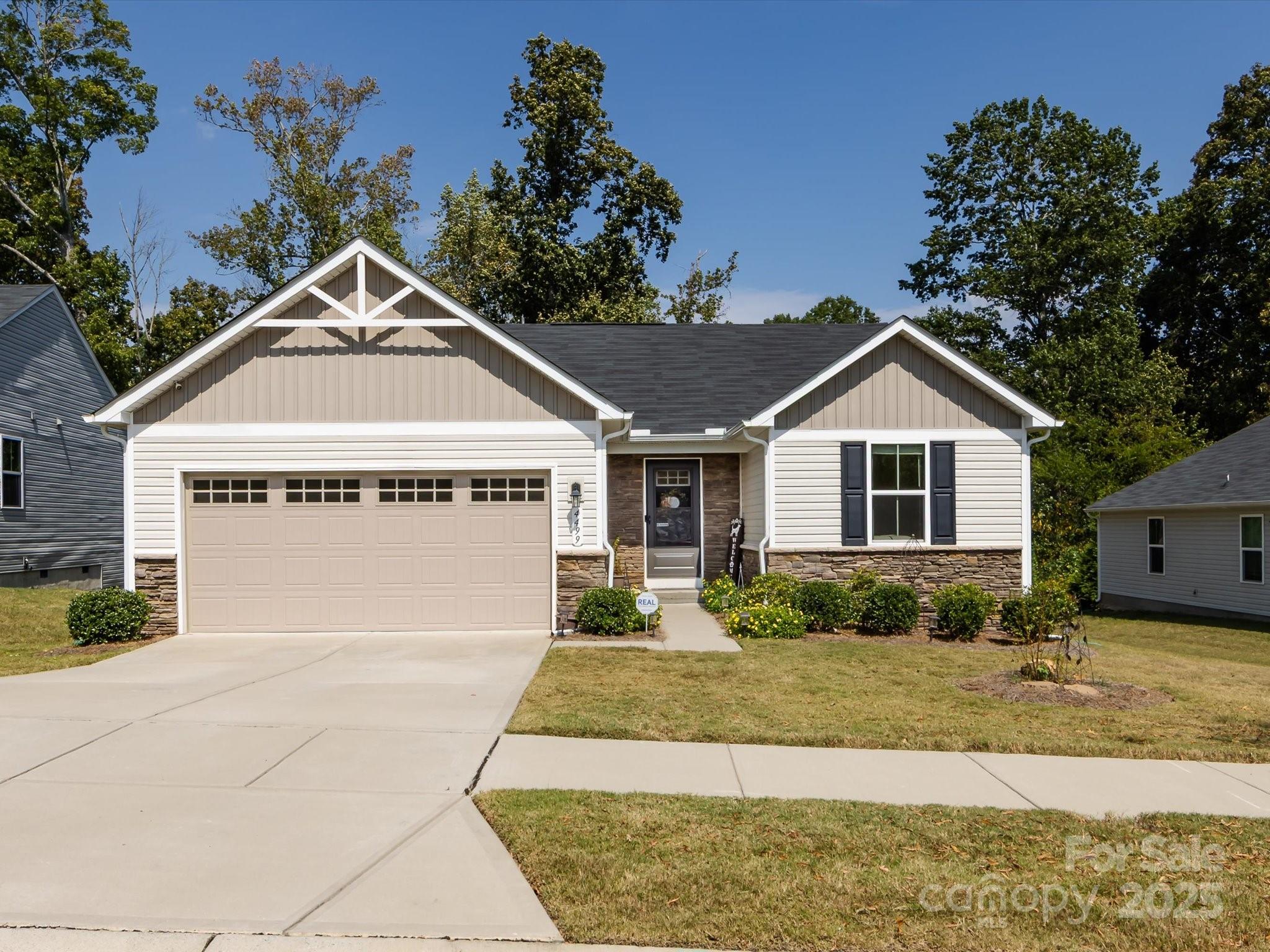 4499 Hunton Dale Road Northwest Concord, NC 28027 - Photo 3 of 43 a front view of a house with a yard and garage