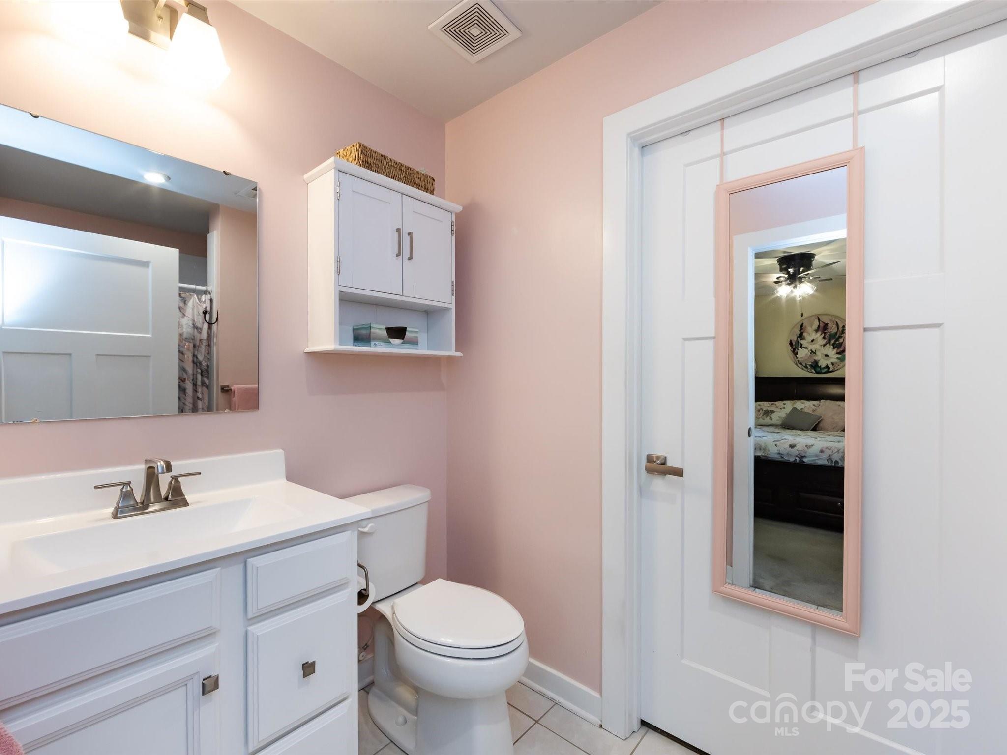 4499 Hunton Dale Road Northwest Concord, NC 28027 - Photo 31 of 43 a bathroom with a toilet sink and mirror