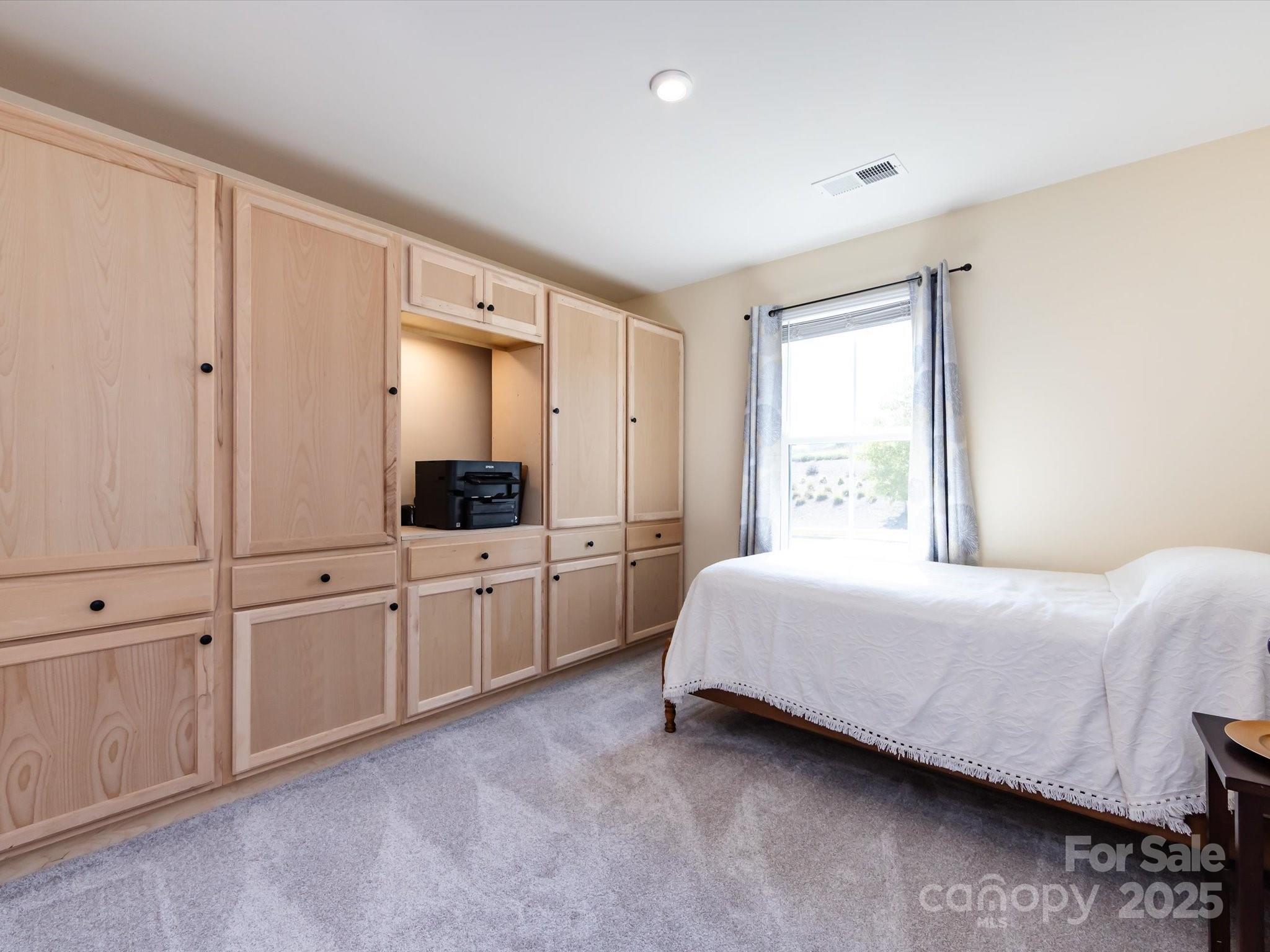 4499 Hunton Dale Road Northwest Concord, NC 28027 - Photo 32 of 43 a room with a bed a mirror on dresser and a window