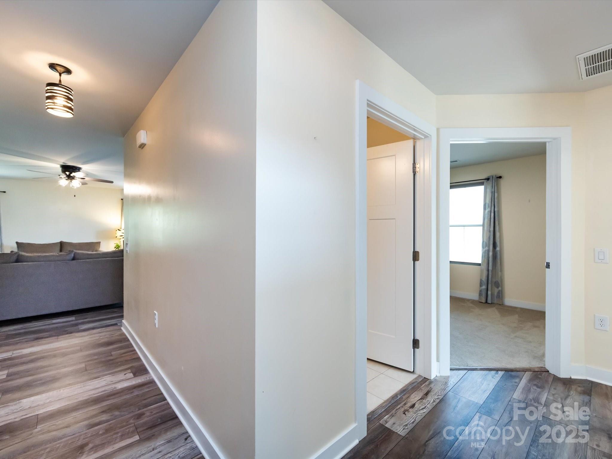 4499 Hunton Dale Road Northwest Concord, NC 28027 - Photo 7 of 43 a view of a hallway with wooden floor and staircase