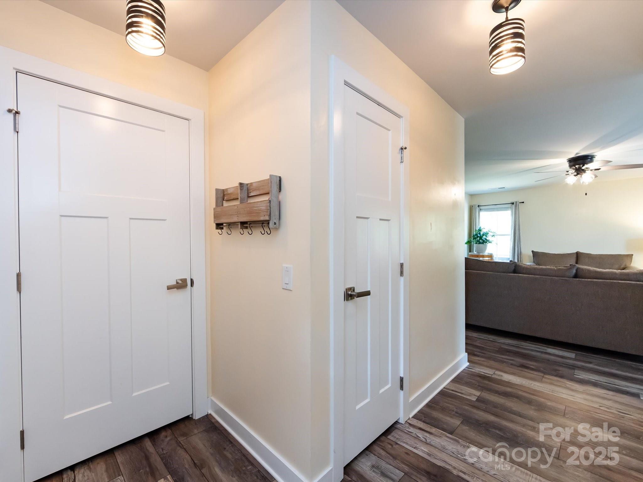 4499 Hunton Dale Road Northwest Concord, NC 28027 - Photo 8 of 43 a view of a hallway with wooden floor and a bathroom