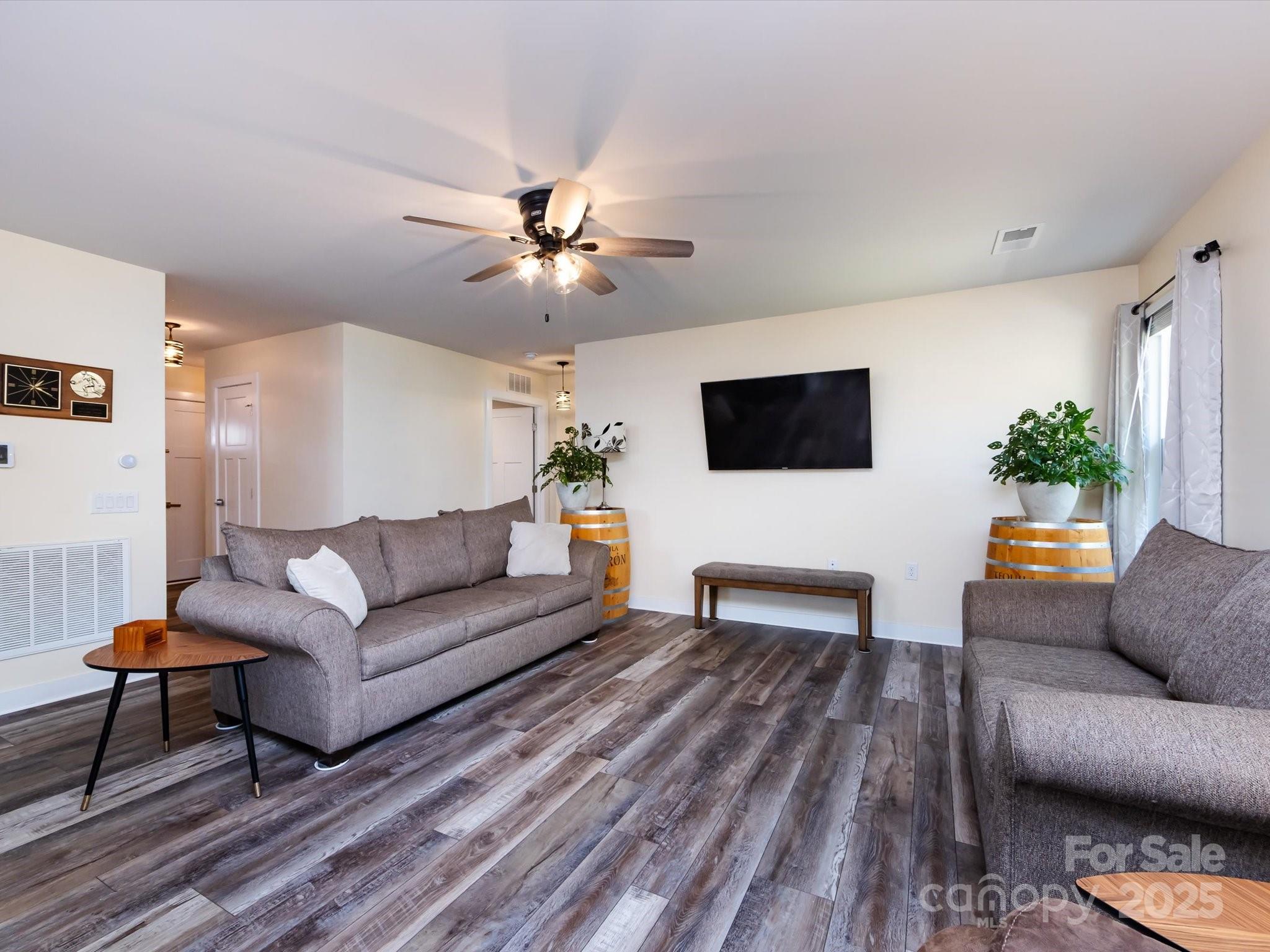 4499 Hunton Dale Road Northwest Concord, NC 28027 - Photo 9 of 43 a living room with furniture and a flat screen tv