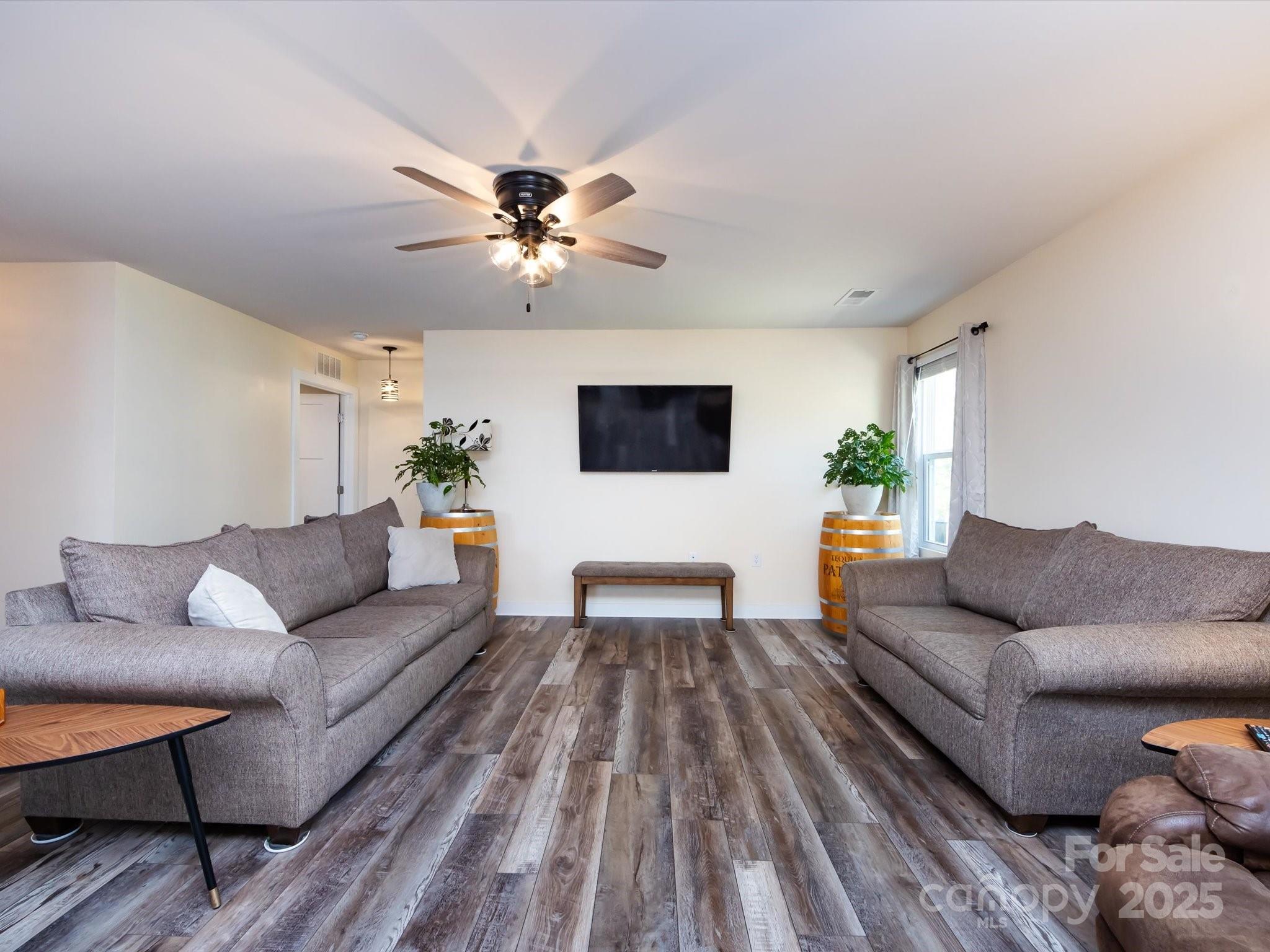 4499 Hunton Dale Road Northwest Concord, NC 28027 - Photo 10 of 43 a living room with furniture and a flat screen tv