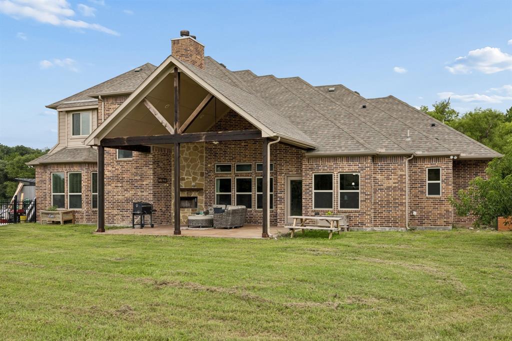 62 Trail Ridge Drive Melissa, TX 75454 - Photo 30 of 39 Huge covered patio with stone fireplace, perfect for relaxing or entertaining