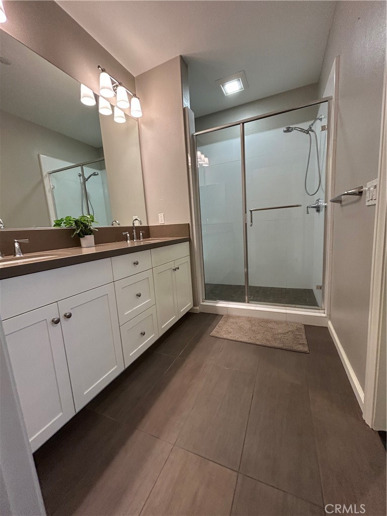 134 Rodeo Irvine, CA 92602 - Photo 12 of 23 a bathroom with a double vanity sink and a mirror