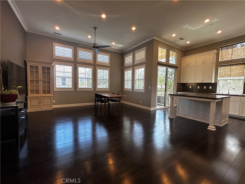 134 Rodeo Irvine, CA 92602 - Photo 4 of 23 a view of empty room with wooden floor and a kitchen