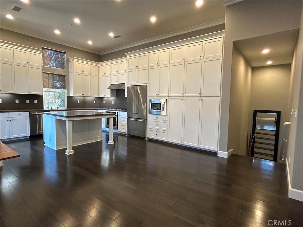 134 Rodeo Irvine, CA 92602 - Photo 8 of 23 a view of kitchen with stainless steel appliances wooden floor and dining table