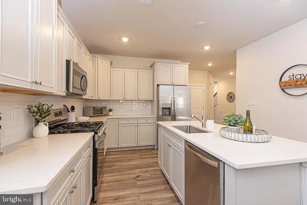a kitchen with a sink a stove and cabinets