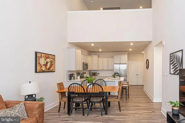 a dinning room with furniture and wooden floor