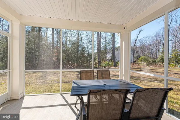 a view of a city from a dining room with a table and chairs