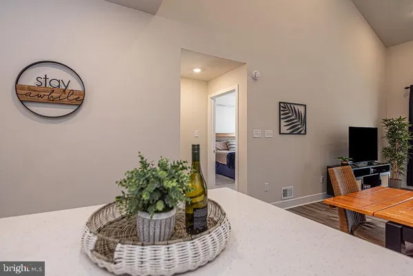 a bedroom with a bed and a dresser next to a window