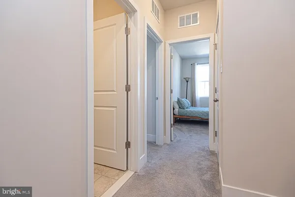 a bed sitting in a bedroom next to a window
