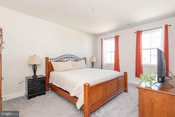 a bedroom with a bed and cabinets