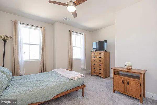 a room with a television and a dresser