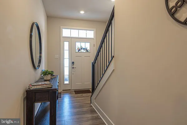 a view of a hallway with wooden floor and windows