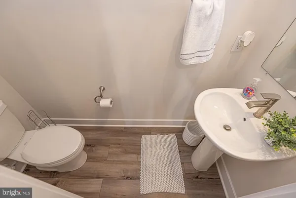 a bathroom with a sink mirror and toilet
