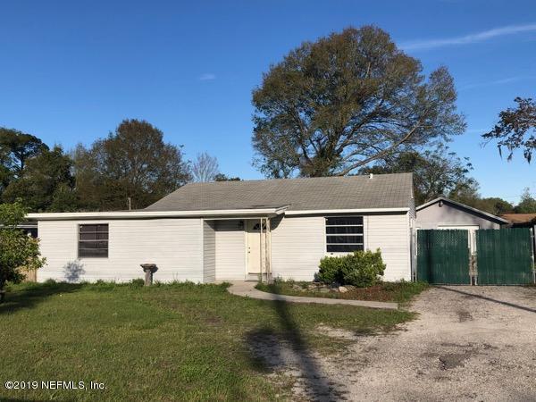 5905 Ricker Road Jacksonville, FL 32244 - Photo 1 of 24 a view of a white house next to a yard with plants and trees