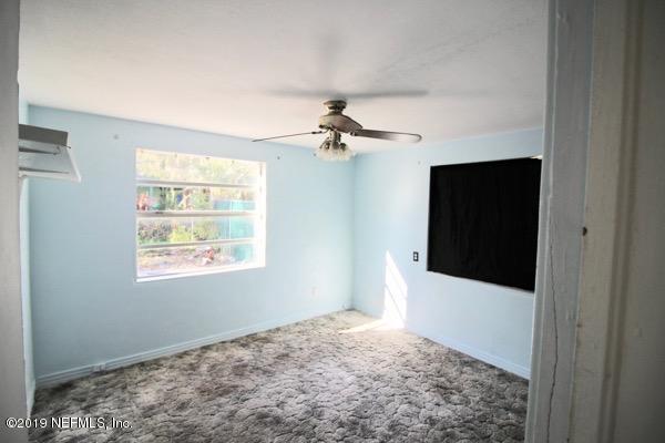 5905 Ricker Road Jacksonville, FL 32244 - Photo 13 of 24 a view of a livingroom with a ceiling fan and window