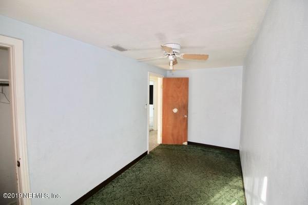 5905 Ricker Road Jacksonville, FL 32244 - Photo 15 of 24 a view of a hallway with a chandelier fan and closet
