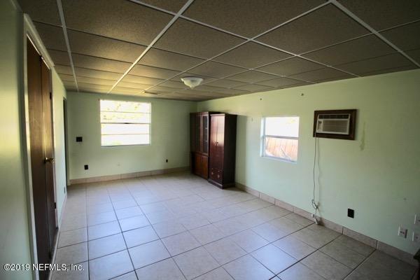 5905 Ricker Road Jacksonville, FL 32244 - Photo 6 of 24 a view of an empty room with window and chandelier
