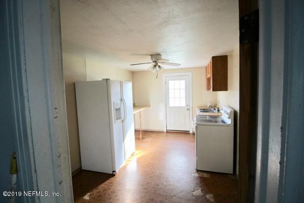 5905 Ricker Road Jacksonville, FL 32244 - Photo 10 of 24 a view of a kitchen with refrigerator and wooden floor