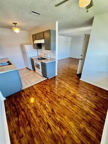 a room with wooden floor and furniture