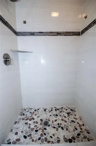a bathroom with a shower and a sink