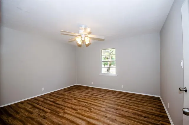 a view of a room with wooden floor and windows
